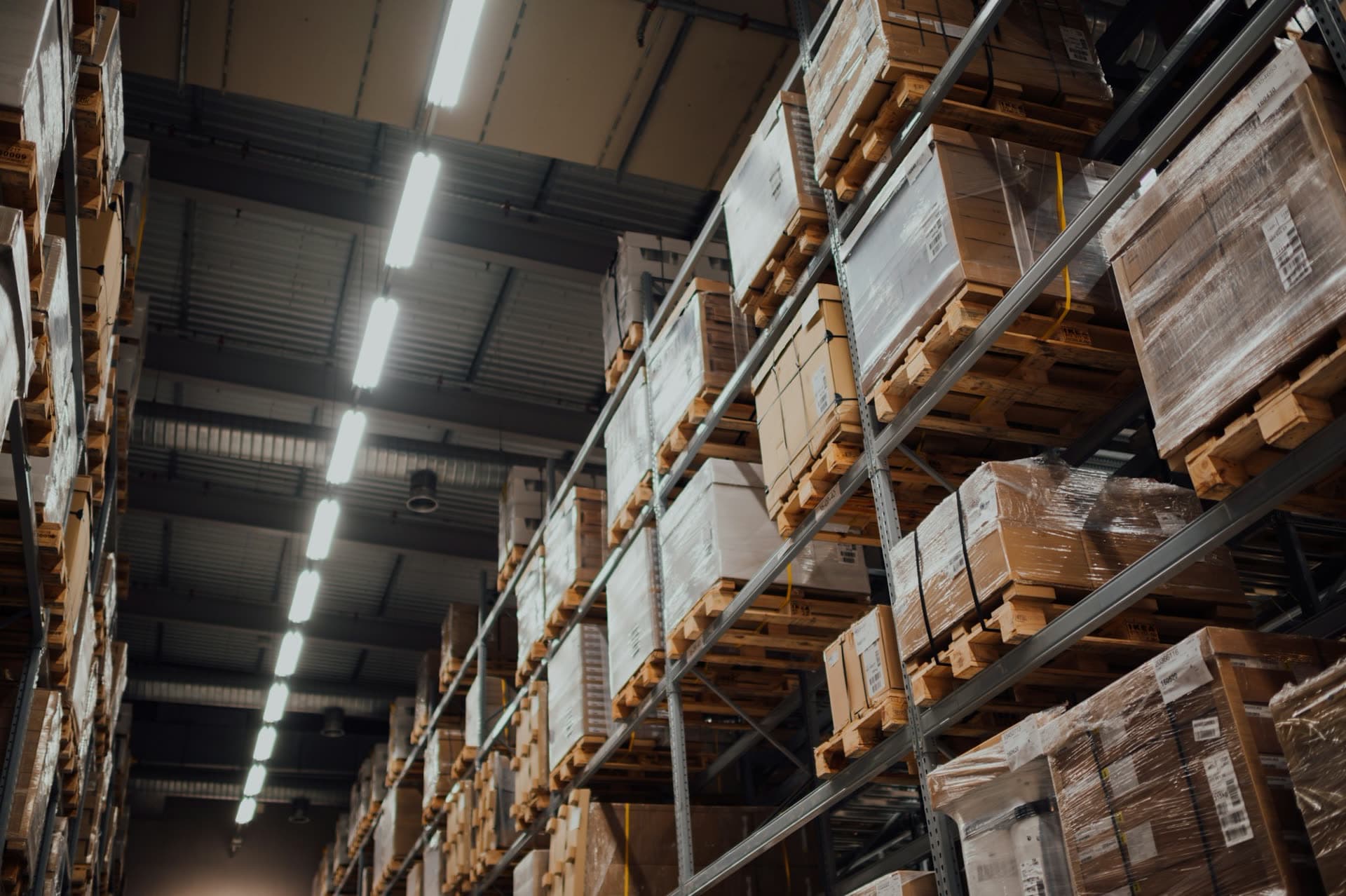 Packages and pallets stored on warehouse racks, ready for freight handling